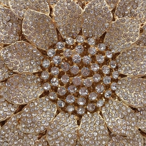 Golden sunflower clutch bag encrusted with sparkling white rhinestones for evening events