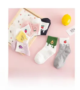 Detailed close-up of colorful fruit embroidery on white cotton socks for casual wear