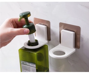 Detail showing tool-free adhesive wall mount holder for shower gel and shampoo bottles