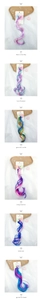 Close-up of colorful rainbow hair extensions with bow clips for children hair styling