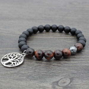 Tiger eye and lava stone mala bracelet with silver tree of life charm on wood background