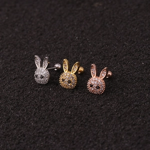 Three cute zircon bunny stud earrings in silver, gold, and rose gold on black background