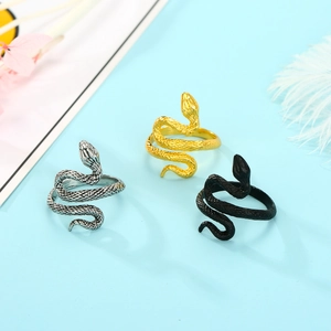 Snake rings in silver, gold, and black with realistic scale textures on blue background