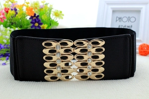 Detail of black elastic wide waist belt featuring a gold hollow buckle with white rhinestones