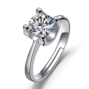 Detail of a sparkling round zircon solitaire ring with classic four-prong setting and adjustable band
