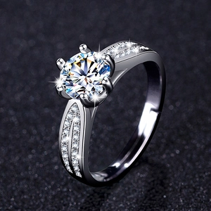 Close-up of a classic six-prong zircon ring with pavé-set split shank in polished silver