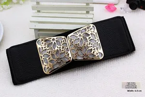 Detail of 6.0cm wide black belt EL72 with gold floral buckle on white woven background