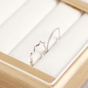Macro view of S925 sterling silver ring set with wavy curve and beaded texture details