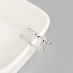 Close-up of S925 sterling silver Mobius rings featuring minimalist wavy and beaded textures