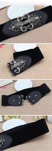 Detail view of black elastic wide waist belt with vintage silver patterned metal buckle
