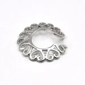 Close-up of silver non-piercing heart ring with hollowed-out metal design