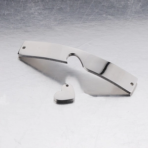 Close-up of heart-shaped charm and curved stainless steel bar for DIY bracelet making