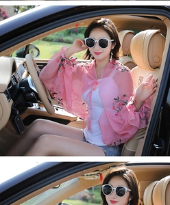 Close-up of pink embroidered chiffon sun protection cardigan with tie-front detail