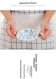 Close-up of ceramic dip bowl with blue spiral pattern and brown handles for dipping