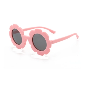 Pink flower-shaped children sunglasses with dark grey round lenses on a white background