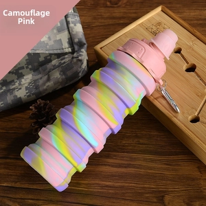 Detailed top view of pink camouflage collapsible silicone water bottle on a wooden table