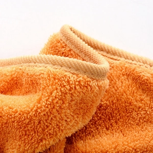 Detailed close-up of soft orange coral fleece hand towel with reinforced stitched edges
