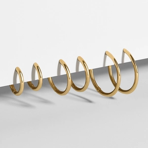 Multiple sizes of polished 18K gold-plated stainless steel hoop earrings in a set