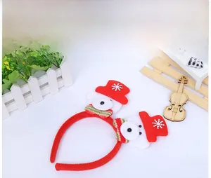 Detail of Christmas headband with glowing snowman figures and red festive velvet fabric