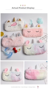 Close-up of soft plush unicorn pencil cases with glitter horns and embroidered eyes