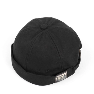 Detail of black canvas docker hat with vintage denim patch and metal eyelets