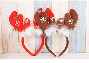 Detail of Christmas reindeer antler headbands with golden bells and snowflake patterns