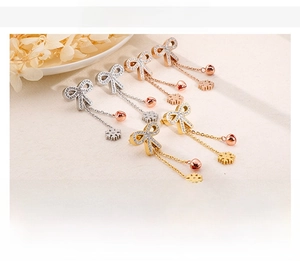 Detailed view of titanium steel bow earrings in gold, silver, and rose gold finishes