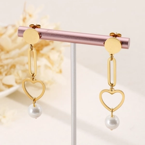Elegant gold heart earrings with white pearls and oval links on a display stand