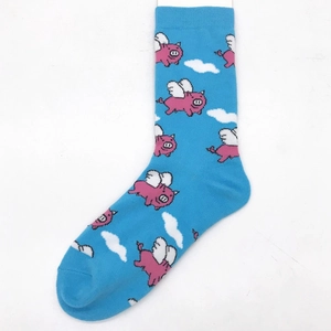 Detail view of blue cotton sock featuring pink winged pigs and white cloud patterns