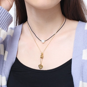 Double-layered gold necklace with black cord, white pearl, and Love heart pendant