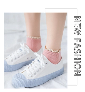 Close-up of pink cotton short socks with delicate lace trim and vertical stripe texture