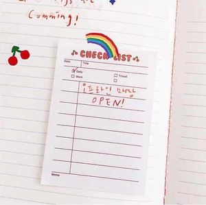 Close-up of cute cherry striped paper check list memo pad with daily task organizer