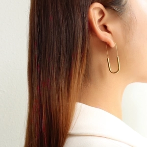 Minimalist long gold safety pin earrings in 18K gold plated stainless steel on model