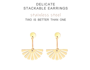 Detailed macro view of gold fan-shaped stainless steel stackable earrings on white background