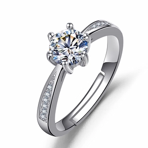 Macro view of six-prong moissanite ring with side accent diamonds and adjustable band