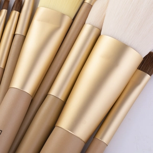 Detail of 9 professional makeup brushes with champagne gold ferrules and soft bristles