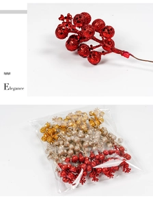 Close-up of glitter-coated red Christmas berry stems with assorted gold and silver sets