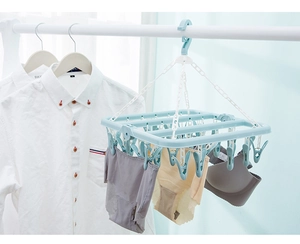 Blue folding drying rack with 32 clips holding underwear and socks on a hanger