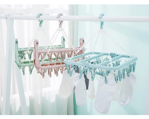 Detail of 32-clip folding laundry hanger in pastel green, pink and blue shades