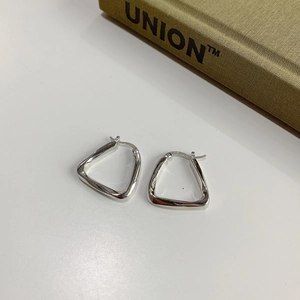 Macro shot of S925 sterling silver geometric earrings with minimalist faceted design