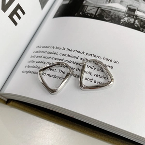 Close-up of geometric 925 sterling silver triangle hoop earrings with S925 hallmark