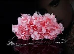 Close-up of pink petal flower evening clutch with metal ball clasp and chain