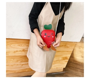 Close-up of a cute carrot-shaped shoulder bag for kids with fine leather texture