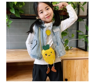 Girl wearing a cute carrot-shaped yellow shoulder bag with animated face details