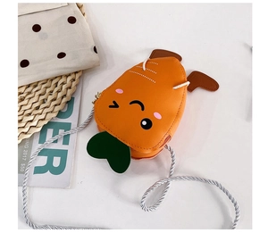 Detail shot of mini carrot shoulder bag with orange finish and green leaves