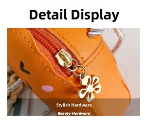 Detail of cute carrot mini bag showing high-quality gold flower-shaped zipper puller