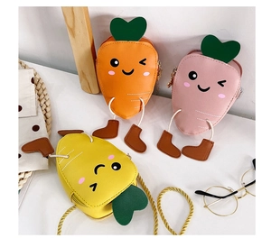 Detailed flat lay of cute carrot-shaped kids crossbody bags in orange, pink, and yellow