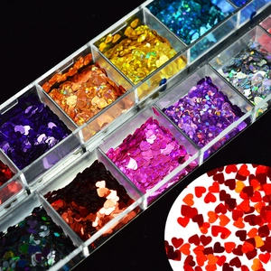 Close-up of colorful heart-shaped nail art glitters in a 12-slot clear storage box