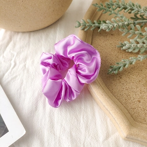 Detail of lavender satin scrunchie with silky luster on elegant decorative tray