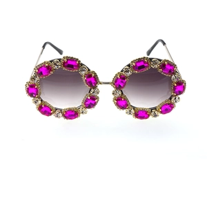 Detail of rose red crystal rhinestones and silver metal frame on oversized round sunglasses